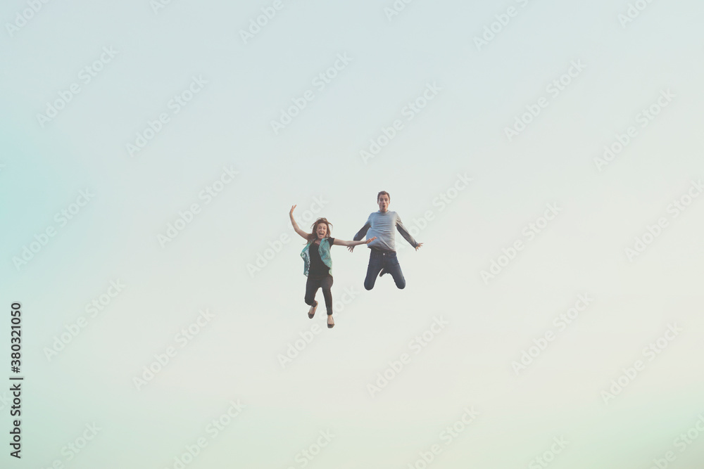 Young happy couple floating in air Young happy couple floating in air