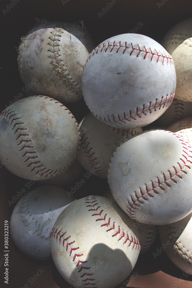 A bunch of old softballs and baseballs A bunch of old softballs and baseballs