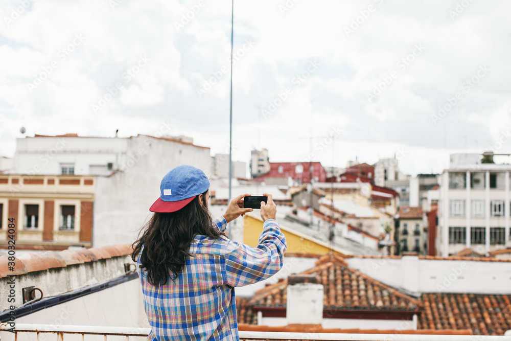 Young hipster man taking photo of beautiful views. Young hipster man taking photo of beautiful views.