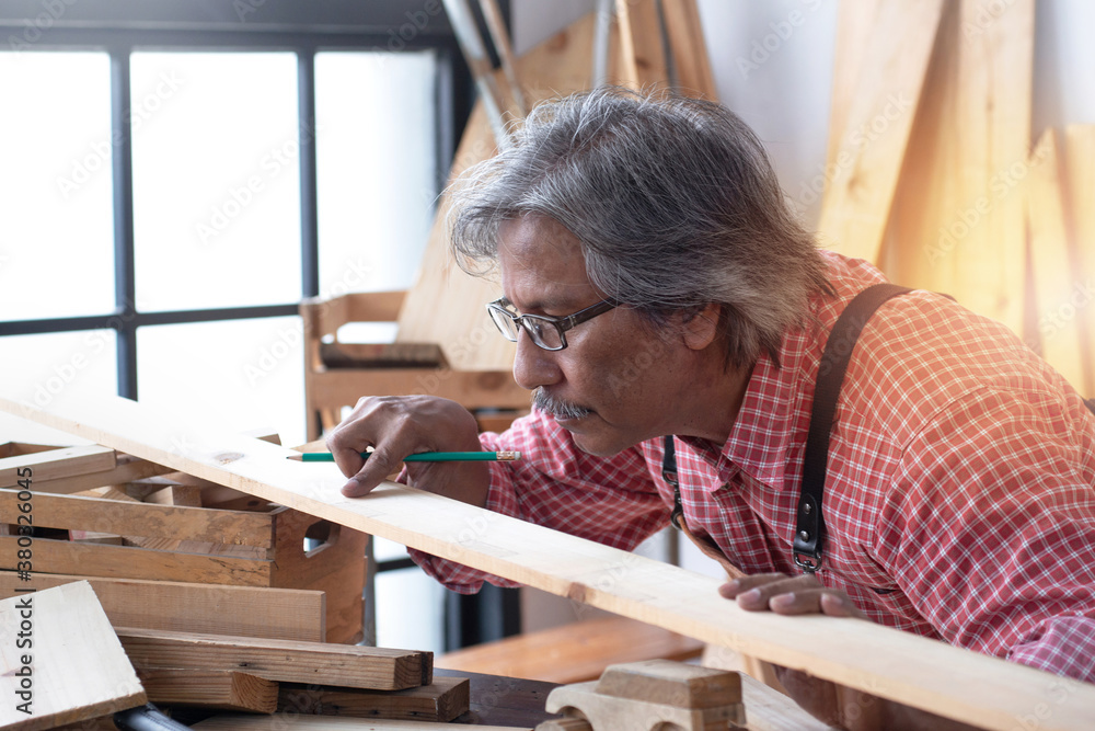 Asian senior carpenters working in the workshop, concept of wood working Asian senior carpenters working in the workshop, concept of wood working