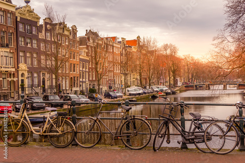 Amsterdam canal and bikes during a sunset