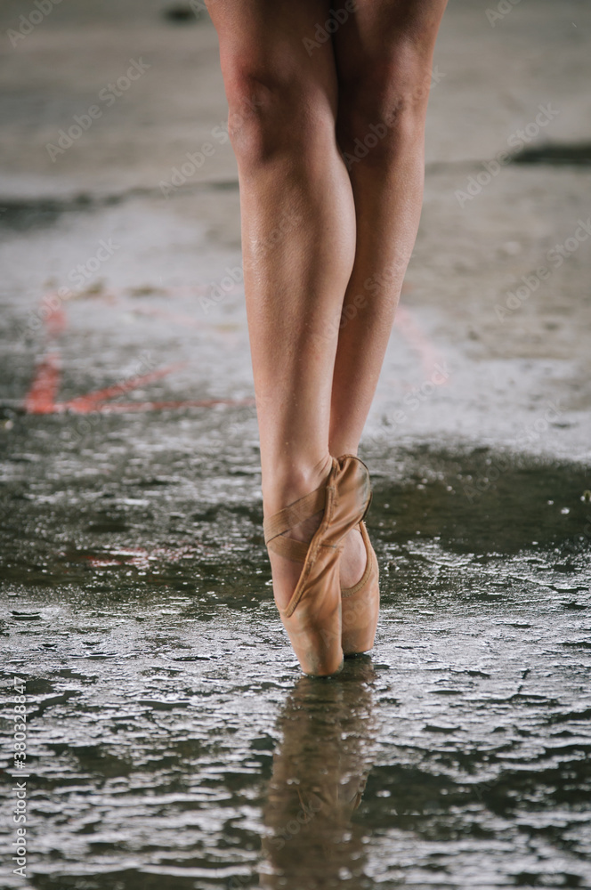 detail of ballet dancer's feet in an urban warehouse setting. detail of ballet dancer's feet in an urban warehouse setting.