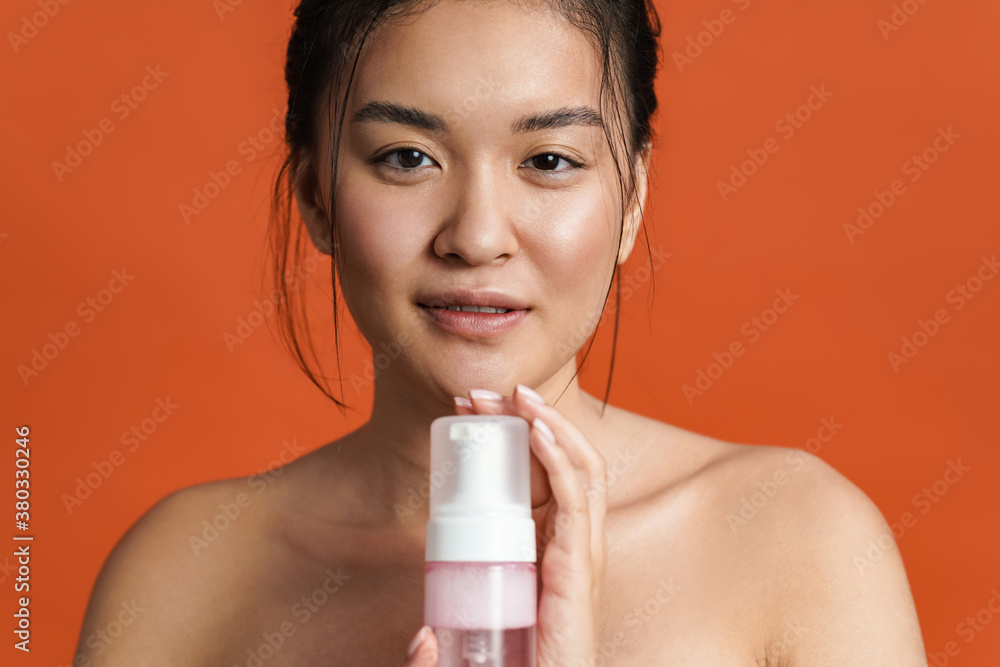 Image of pleased shirtless asian girl posing with cleansing foam Stock