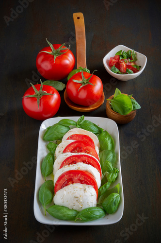 caprese salad  with buffalo mozzarella, tomato and basil with olive oil photo