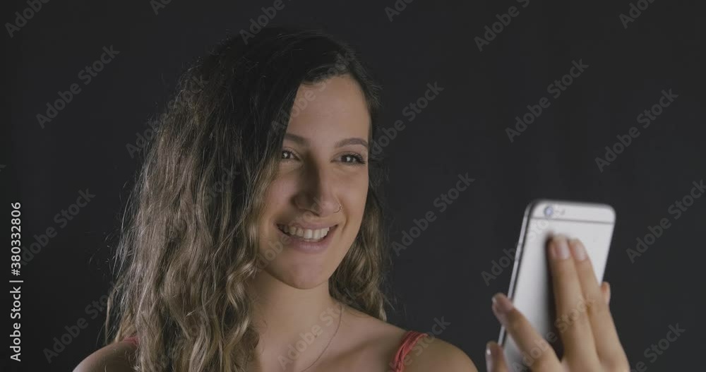 Young beautiful long haired lady looking her smartphone and being happy, success and victory. Winner woman concept. Young beautiful long haired lady looking her smartphone and being happy, success and victory. Winner woman concept.