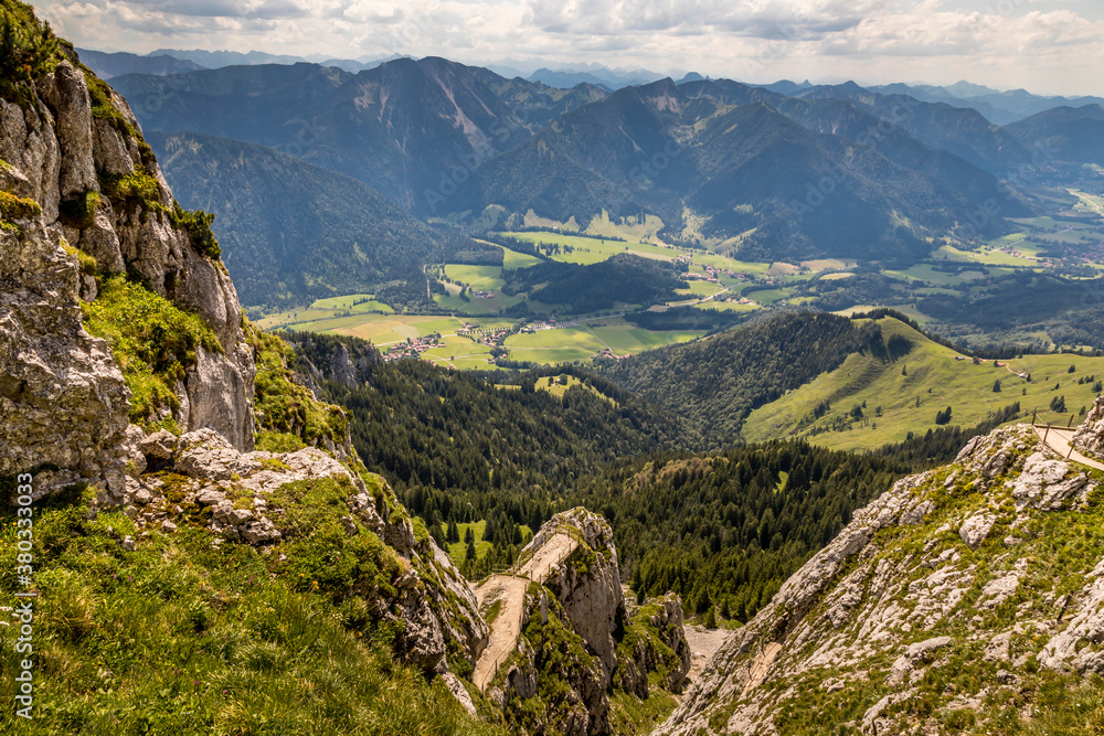 Hiking from the mountain station to the top of the mountain called Wendelstein in Bavaria, Germany at a cloudy day in summer. Beautiful panoramic view.