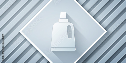 Paper cut Plastic bottle for laundry detergent, bleach, dishwashing liquid or another cleaning agent icon isolated on grey background. Paper art style. Vector.