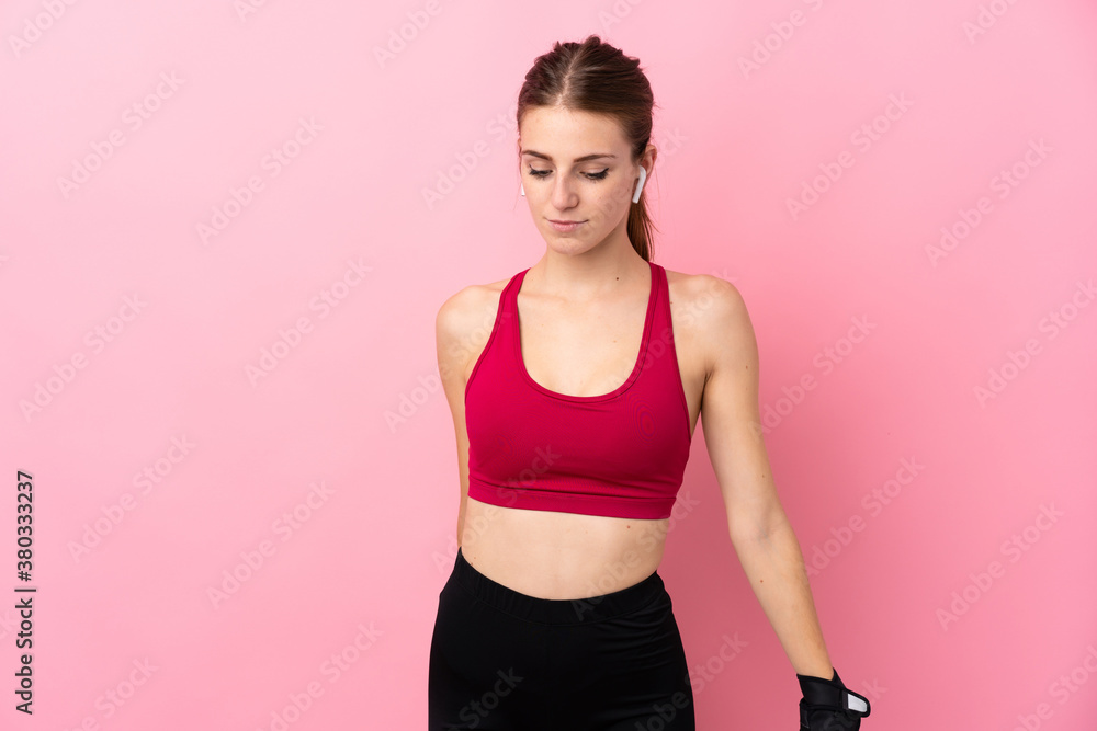 Young sport woman over isolated pink background Young sport woman over isolated pink background