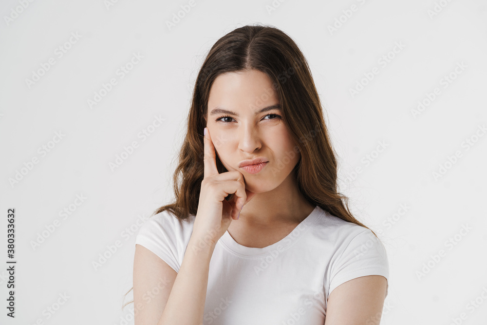 Pensive young woman thinking isolated over white Pensive young woman thinking isolated over white