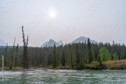 Beautiful river in the mountains of Banff national park against the morning fog.