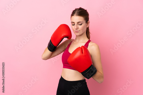 Young sport woman over isolated pink background