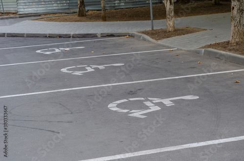 White Wheelchair Icon On A Gray Asphalt Parking Lot