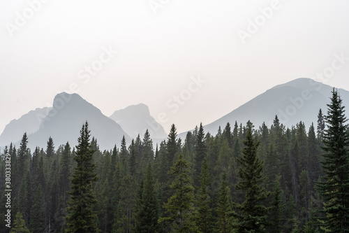 Fototapeta Naklejka Na Ścianę i Meble -  Beautiful silhouette of the mountains in Banff national park against the morning fog.