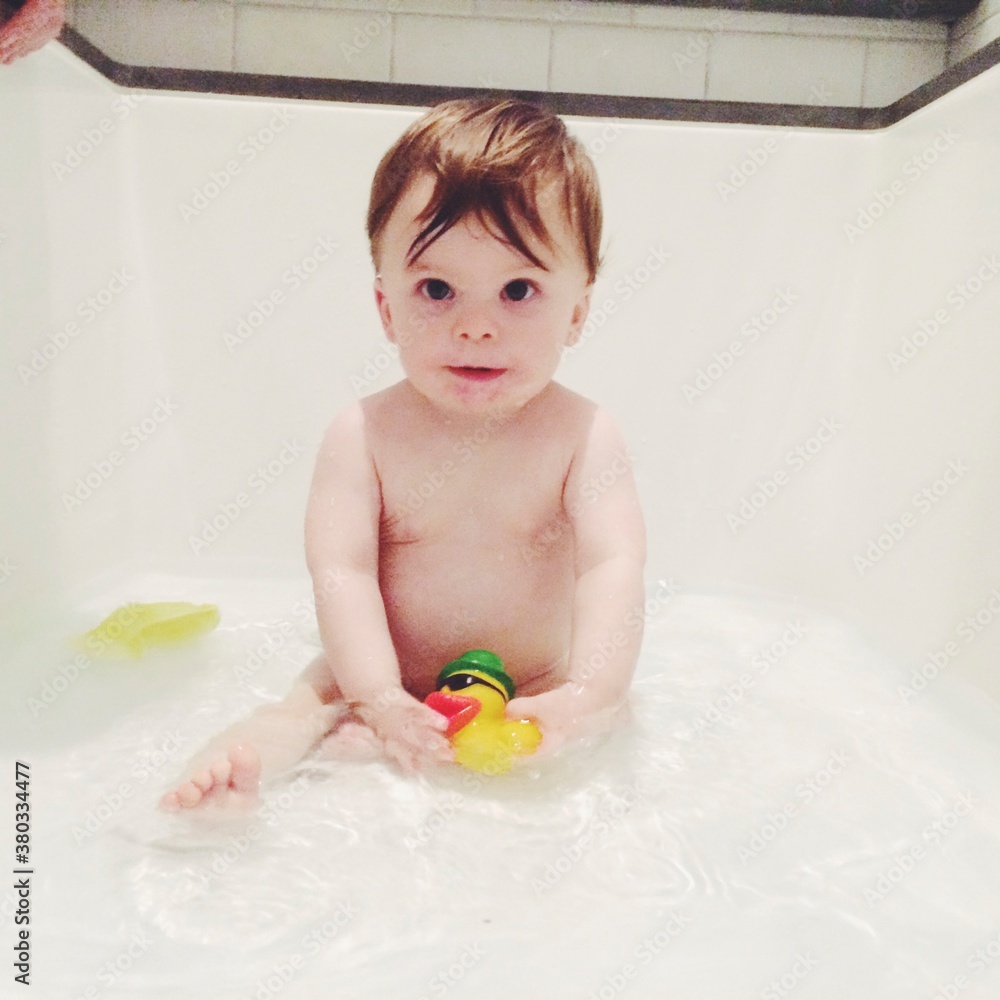 Young baby in a tub taking a bay Young baby in a tub taking a bay