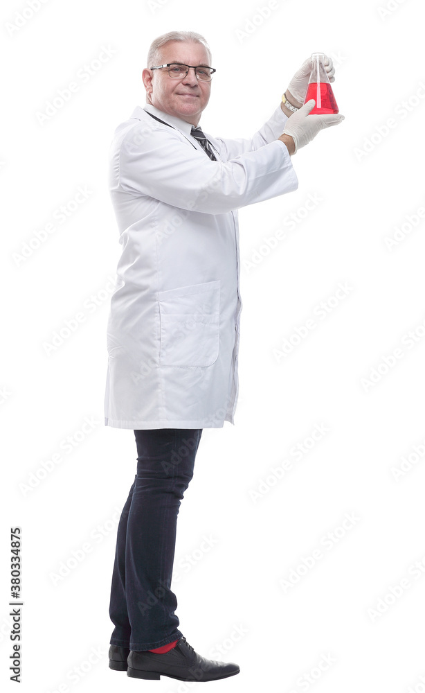 doctor is looking carefully at the liquid in the laboratory bottle .