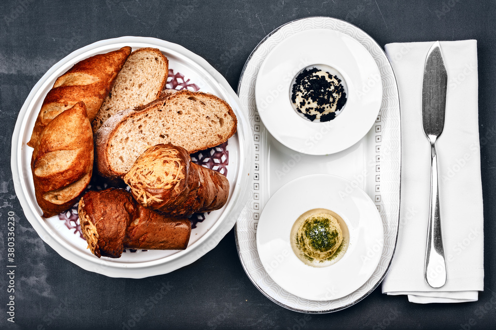 Freshly baked homemade assorted bread and bun traditional breakfast with spicy butter Freshly baked homemade assorted bread and bun traditional breakfast with spicy butter