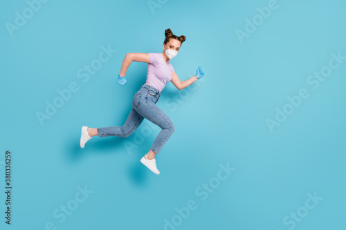 Full length body size view of her she attractive motivated girl youth teenage wearing n95 mask jumping running mers cov prevention healthcare isolated blue pastel color background