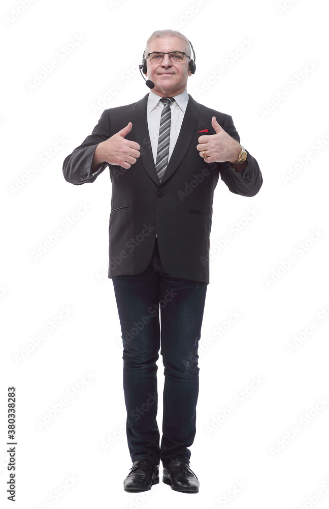 in full growth. confident business man in headset showing OK gesture in full growth. confident business man in headset showing OK gesture