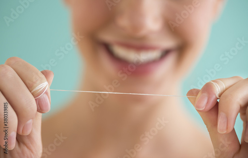 Close-up of woman holding dental floss