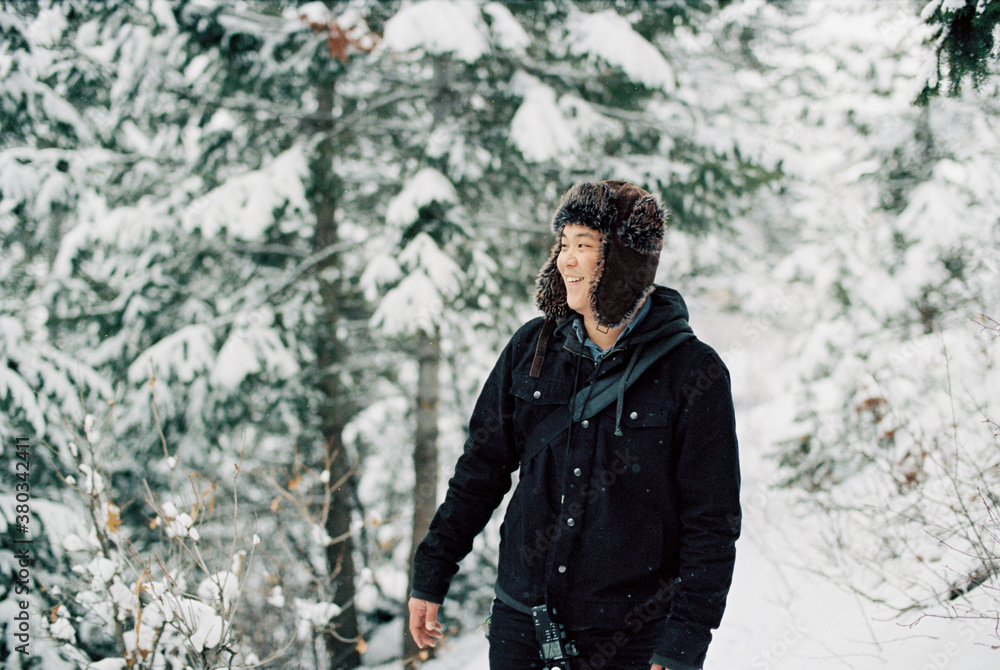 Asian man smiling in snow Asian man smiling in snow
