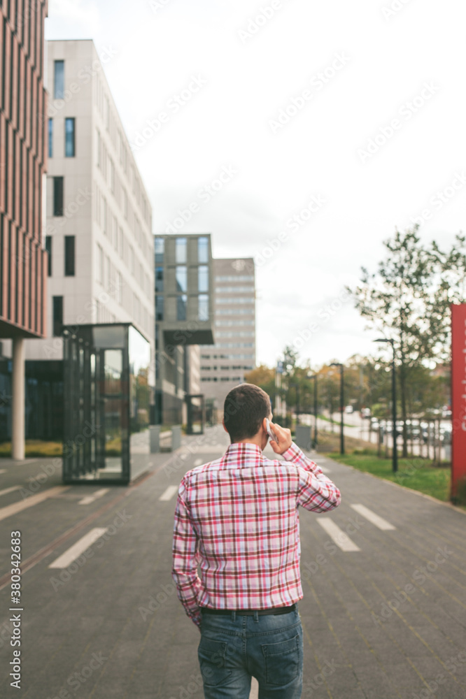 Man in Plaid Shirt Talking on the Phone Man in Plaid Shirt Talking on the Phone