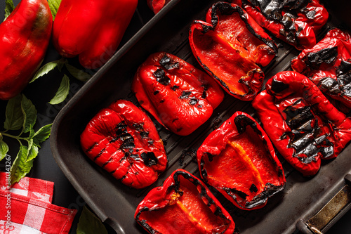 Grilled red peppers on a grill plate close up view