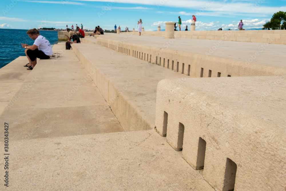 Φωτογραφία Zadar / Croatia - September 2 2020: People sitting by Sea Organ, an architectural sound art located in Zadar, Croatia