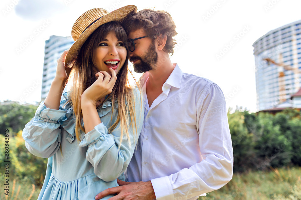 Sunny outdoor fashion image of beautiful magnificent stylish elegant glamour couple Sunny outdoor fashion image of beautiful magnificent stylish elegant glamour couple