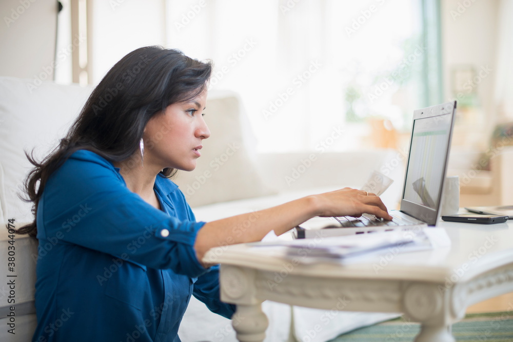 Woman working in living room Woman working in living room