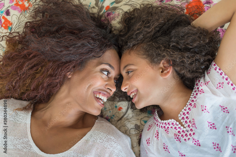 Mother and daughter (8-9) lying on bed Mother and daughter (8-9) lying on bed