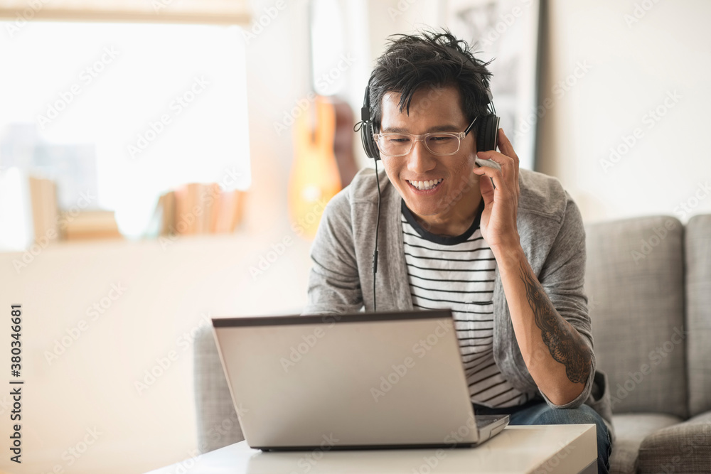 Man mixing music on laptop Man mixing music on laptop