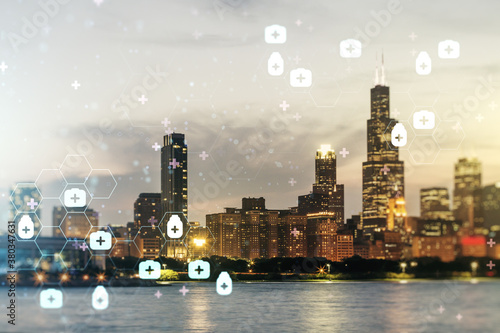 Double exposure of abstract virtual medical hologram on Chicago city skyscrapers background. Healthcare technolody concept photo