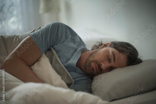 Man sleeping in bed photo