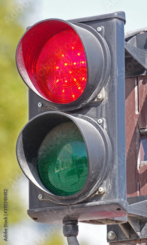 Illuminated red traffic signal light on modern traffic light