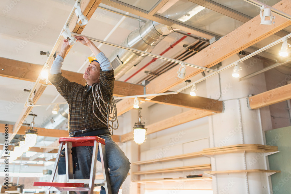 Electrician fixing lightning equipment Electrician fixing lightning equipment