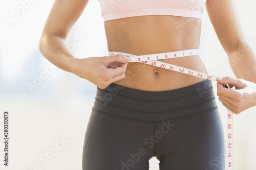 Woman measuring waist photo