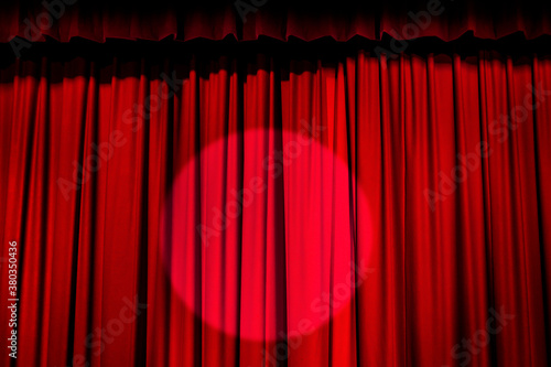 Spotlight on red curtain photo