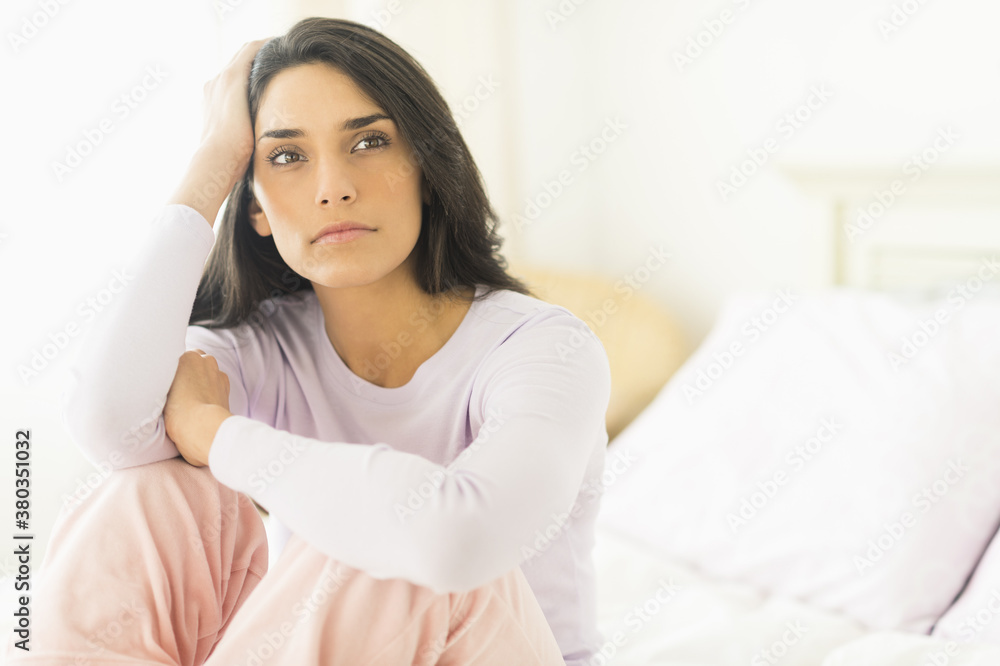 Woman sitting on bed