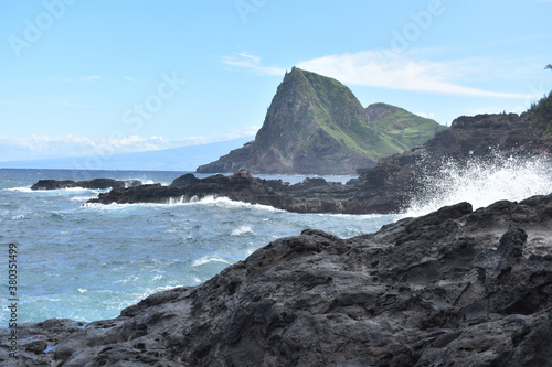 Beautiful shot of waves hitting the rocky shore of the Maui Kahakuloa in the USA photo