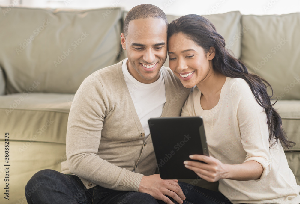 Young couple using digital tablets Young couple using digital tablets