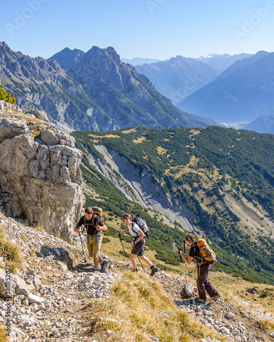 Hiking group on a steep trail in the alps