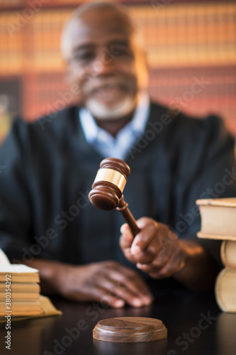 Judge holding gavel in courtroom