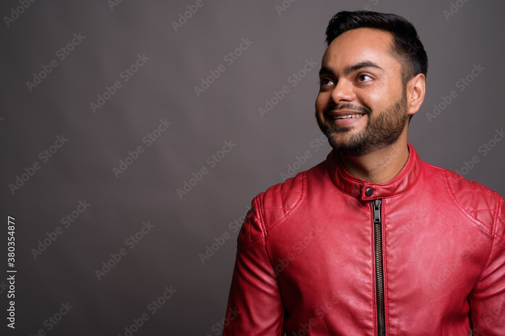 Fototapeta premium Young bearded Indian man against gray background