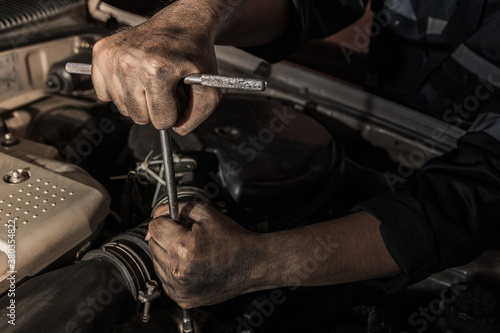 clossup the dirty hands of a auto mechanic is working