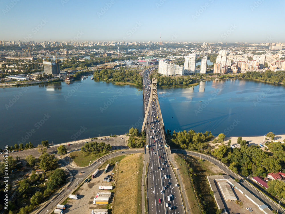 Fototapeta premium Aerial drone view. Automobile North Bridge in Kiev across the Dnieper River. Sunny day.
