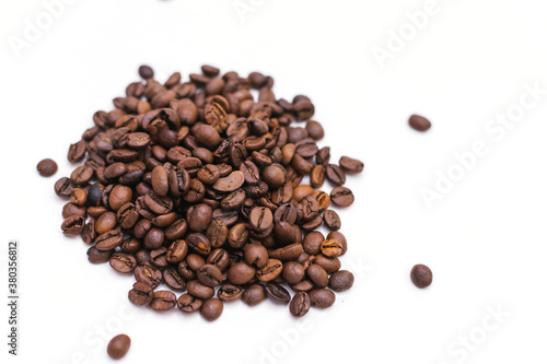 Coffee beans are scattered on a white background.