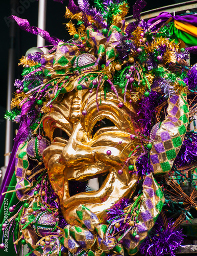 Mardi Gras mask hanging on balcony's railing photo