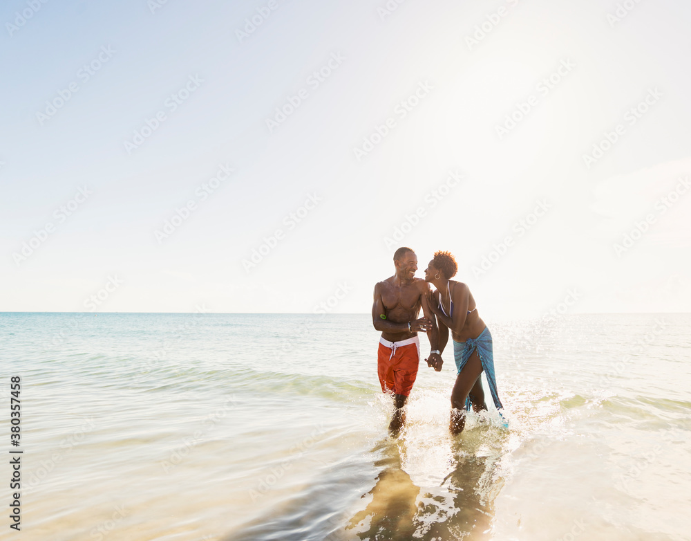 Man and woman holding hands on beach Man and woman holding hands on beach