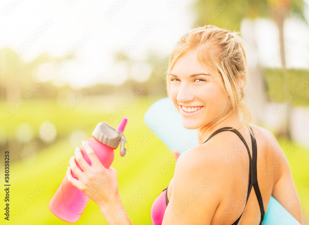 Portrait of smiling woman drinking water Portrait of smiling woman drinking water