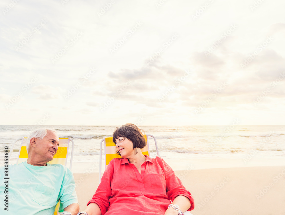 Older couple relaxing on beach Older couple relaxing on beach